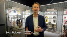 image of Louis Balcaen president of Baobab Collection in navy suit and white shirt, behind him are candles on shelves