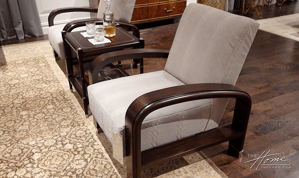 photo of 2 wood chairs with beige cushions on a tan floral wool rug