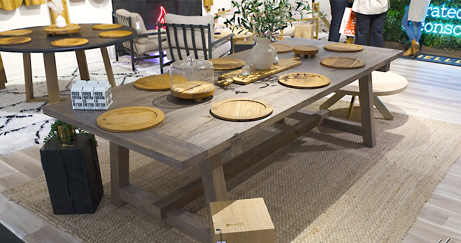 image of large dark brown barn table with round wood placemats on a tan rug