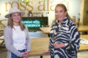 image of woman with tan felt hat and woman with zebra print shirt in wood furniture showroom at High Point Market