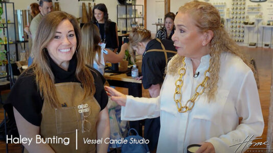 image of woman with tan apron and woman with white shirt and golden necklace in showroom