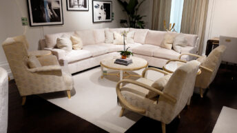 image of living room set with side chairs, cream color furniture and rug