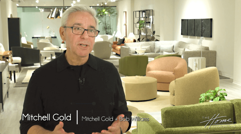 image of man in black shirt with glasses in front of modern iconic chairs and couches