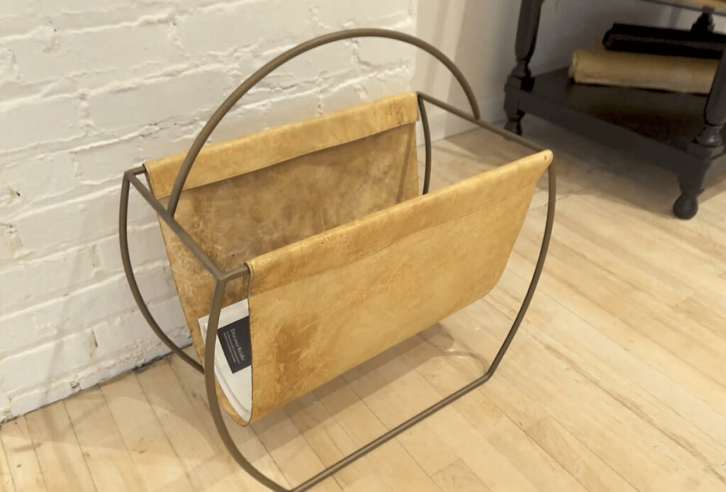 Image: tan alternative leather firewood tote on pine colored flooring