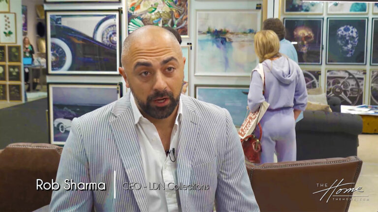 Image: man with dark beard and pinstripe suit jacket in front of wall of framed art prints. Text: Rob Sharma, CEO LDN Collections