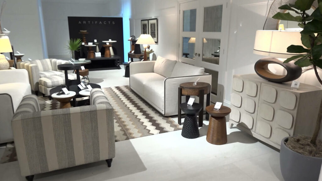 A.R.T. Home Furniture showroom with cream sofas, rug, and wooden accent pieces