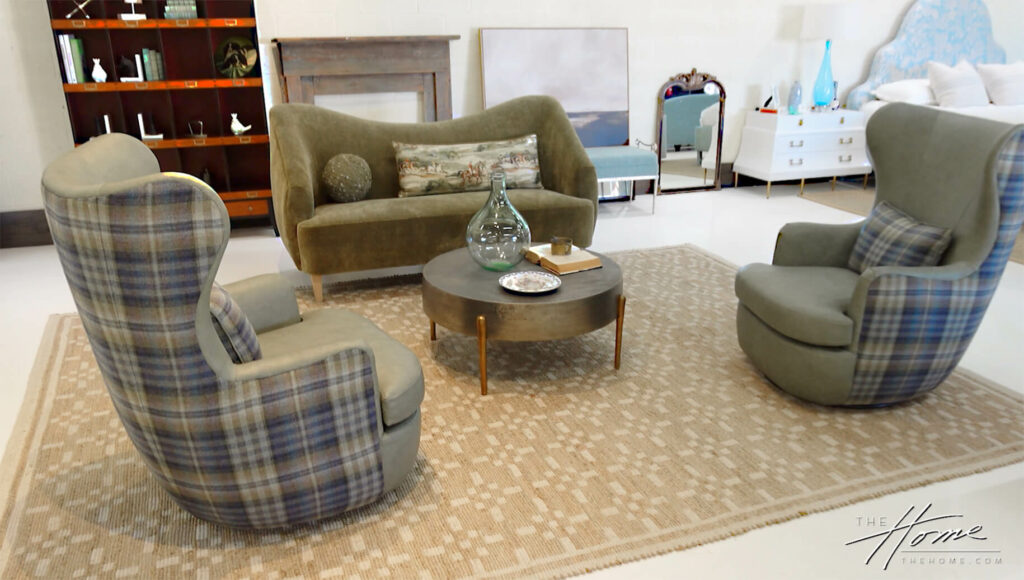 Image: 2 green & gray plaid high back swivel chairs and green sofa on tan carpet with round coffeetabe near blue bed headboard
